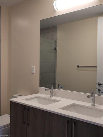 Bathroom with walk in shower, vanity, and toilet