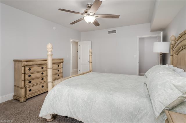 Carpeted bedroom with ceiling fan