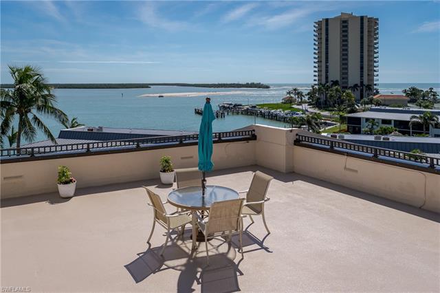 View of patio / terrace with outdoor dining space, a balcony, and a water view