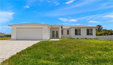 Ranch-style house with a garage and a front yard