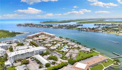 Birds eye view of property with a water view