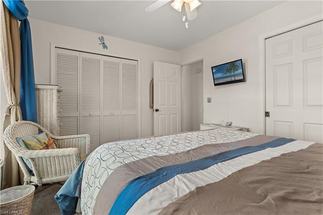 Carpeted bedroom featuring a closet and ceiling fan