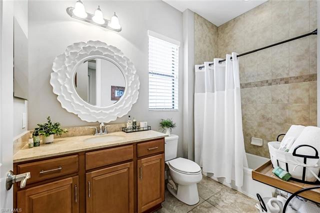 Full bathroom featuring shower / tub combo, tile patterned floors, vanity, and toilet