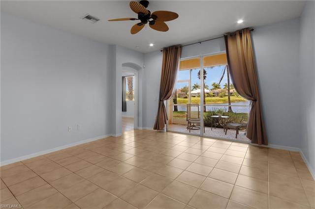 Living room featuring ceiling fan and light tile flooring