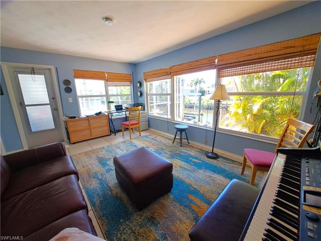 Living room featuring tile patterned flooring and baseboards
