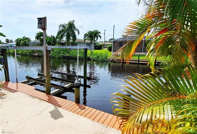 View of dock featuring boat lift and a water view