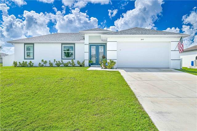 Single story home featuring a garage and a front yard
