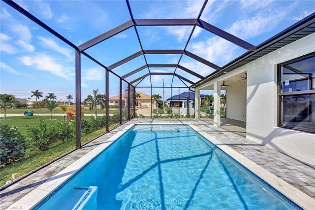 View of pool with a yard, a patio area, a lanai, and ceiling fan
