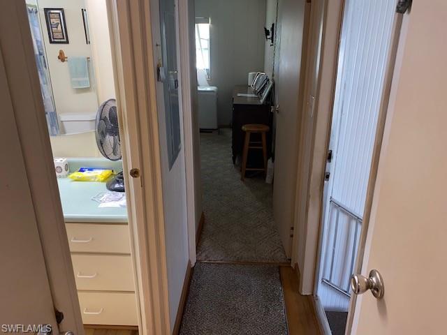 Hallway with dark carpet