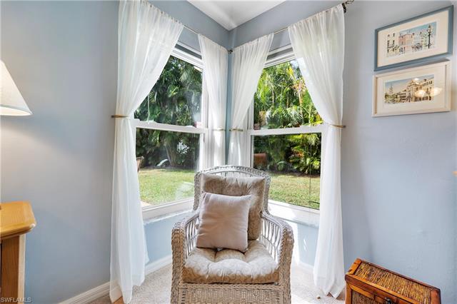 Master bedroom seating area with carpet flooring and a wealth of natural light