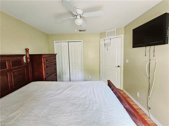 Bedroom with multiple closets and ceiling fan