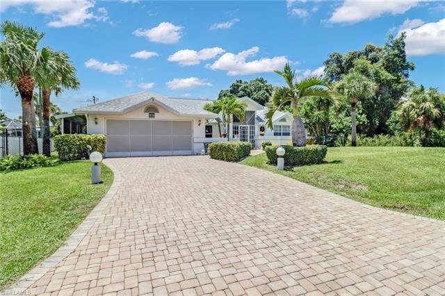 Single story home featuring a front lawn and a garage