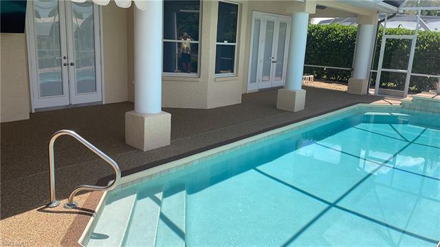 View of swimming pool featuring french doors, a patio, and a lanai