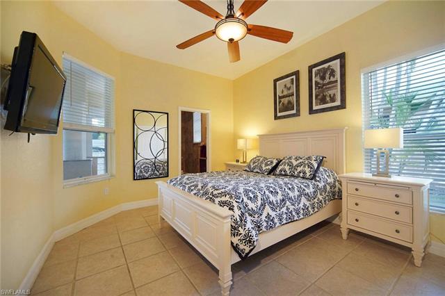 Bedroom with ceiling fan and light tile patterned floors