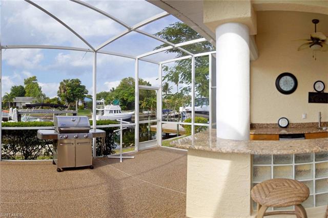 View of patio / terrace with ceiling fan, a lanai, and grilling area