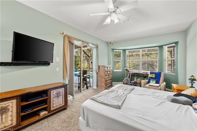 Carpeted bedroom with access to outside and ceiling fan