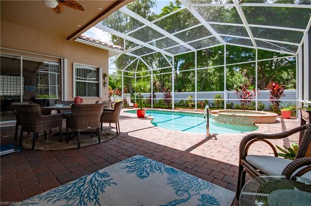 View of swimming pool with an in ground hot tub, a patio, ceiling fan, and a lanai