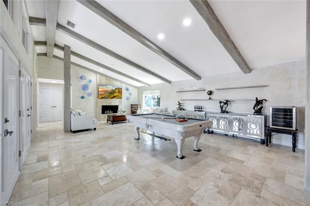 Recreation room with lofted ceiling with beams and pool table