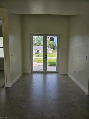 Unfurnished room featuring french doors