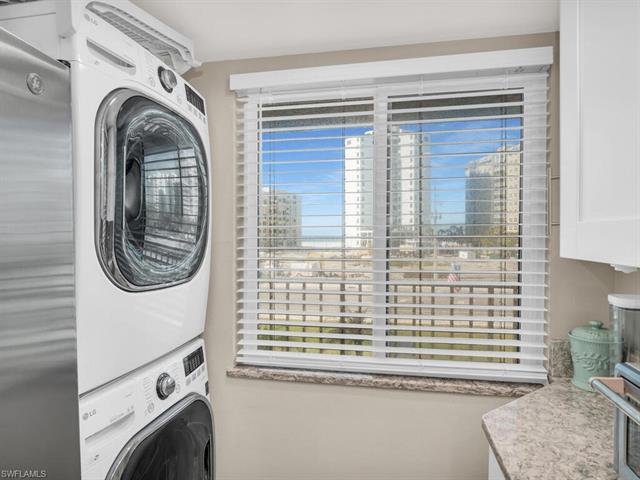 Laundry room featuring stacked washer and clothes dryer