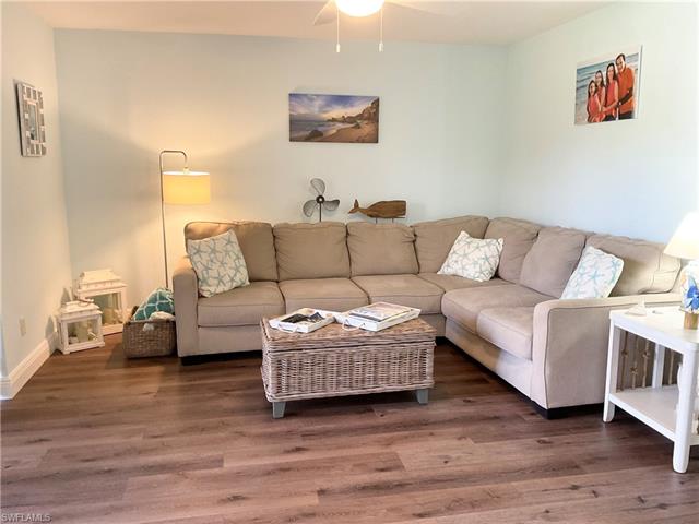Living area with vinyl planked flooring and TV