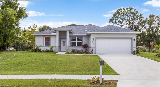 View of front of home featuring a front yard and a garage