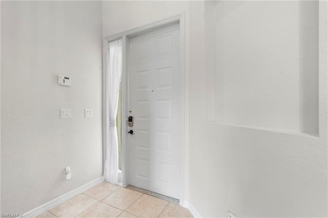 Hall featuring light colored carpet