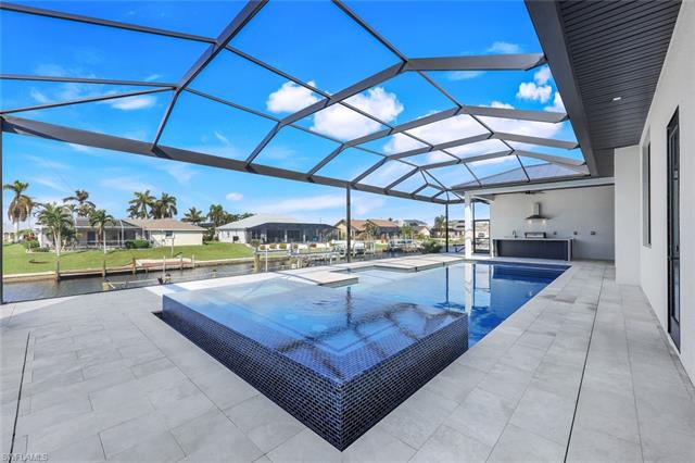 View of pool with a patio area and a lanai