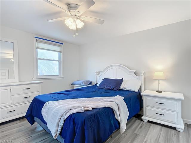 Bedroom with ceiling fan and light wood-type flooring