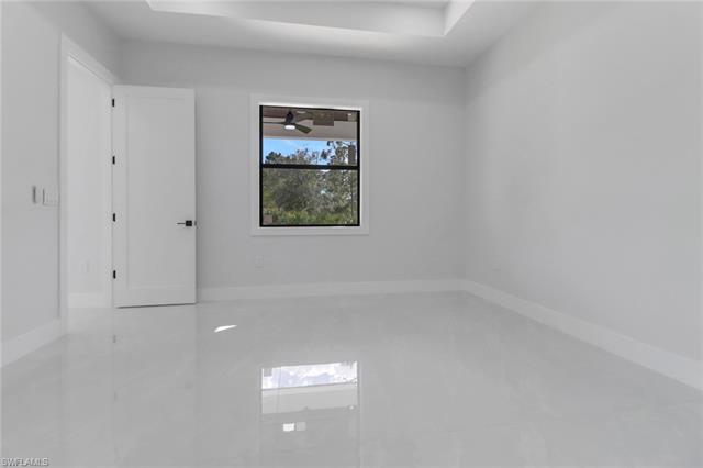 Tiled empty room featuring ceiling fan