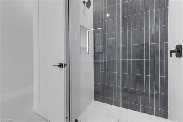 Bathroom featuring a shower with door