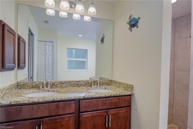 Bathroom with vanity and a tile shower