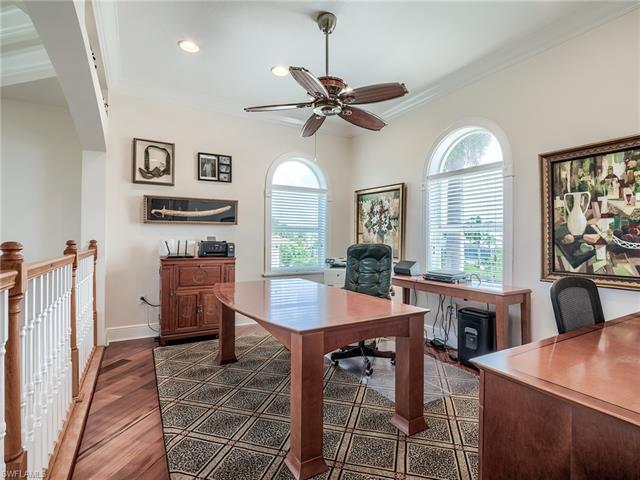Office area featuring ceiling fan, crown molding, and dark wood-type flooring