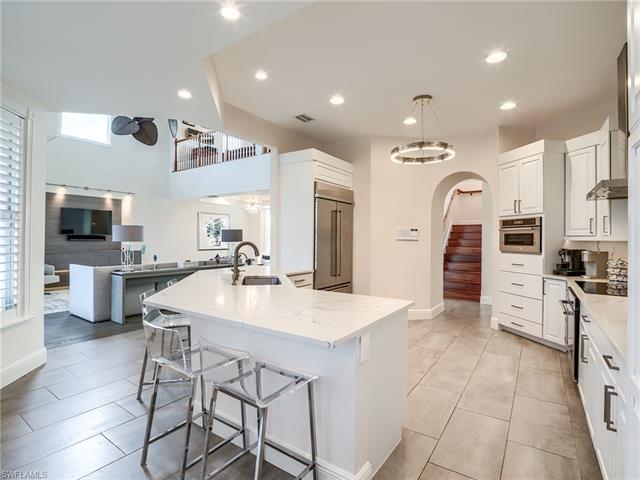Kitchen featuring appliances with stainless steel finishes, a wealth of natural light, ceiling fan, and sink