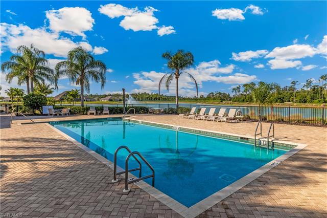 View of pool with a patio area and a water view