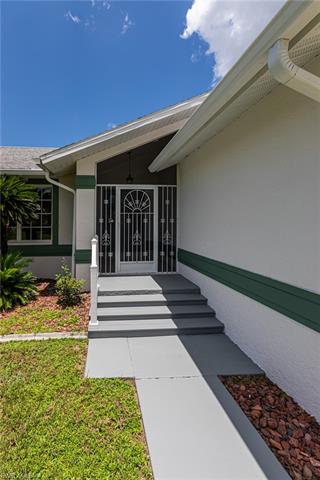 Entrance to property featuring ceiling fan