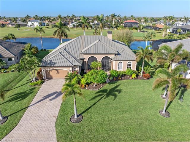 View of front of home with a front yard, a garage, and a water view