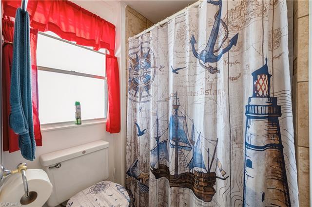 Full bathroom featuring a shower with shower curtain and toilet