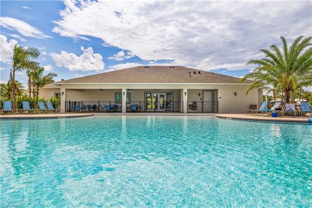View of pool with ceiling fan and a patio