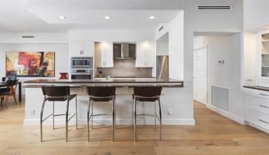 Sleek, updated kitchen with an oversized island and high-end appliances.