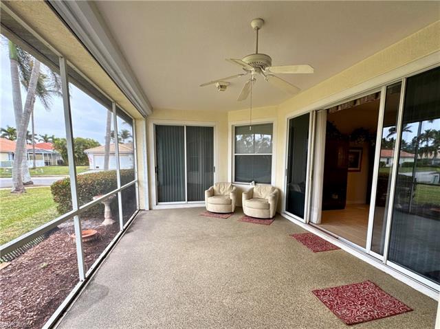 Unfurnished sunroom featuring ceiling fan