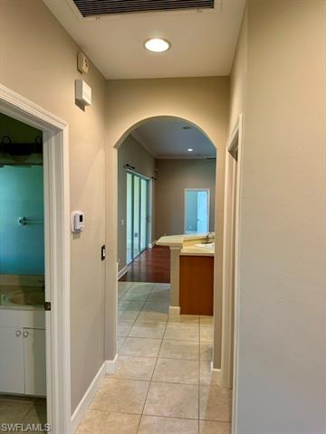 Hallway featuring sink and light hardwood / wood-style floors