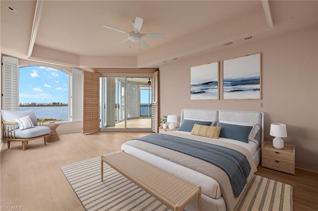 Virtually Staged. Bedroom featuring access to outside, multiple windows, a water view, and wood finished floors