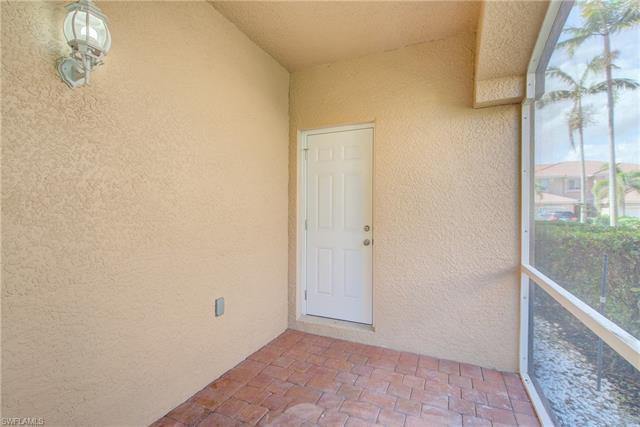 Doorway to property featuring stucco siding