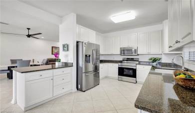 Beautiful clean and light kitchen with white shaker cabinetry and stainless steel appliances!