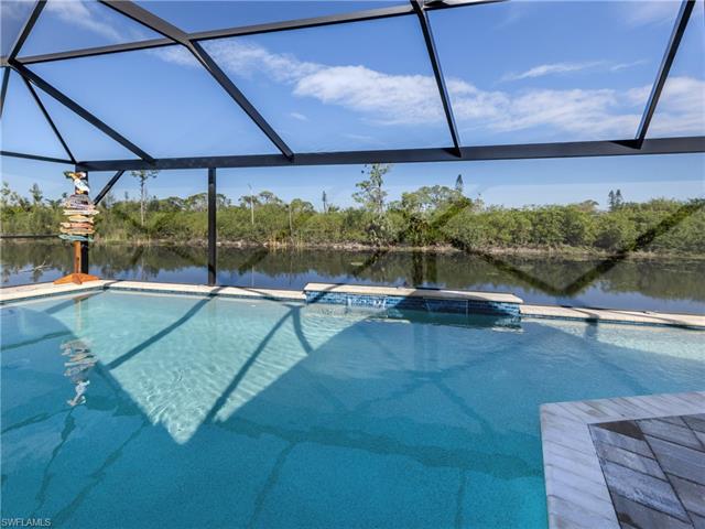 Outdoor pool with a water view and a lanai