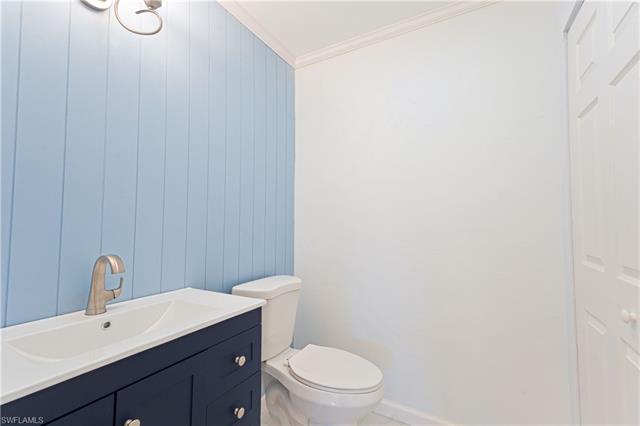 Powder room is conveniently located just off the kitchen.