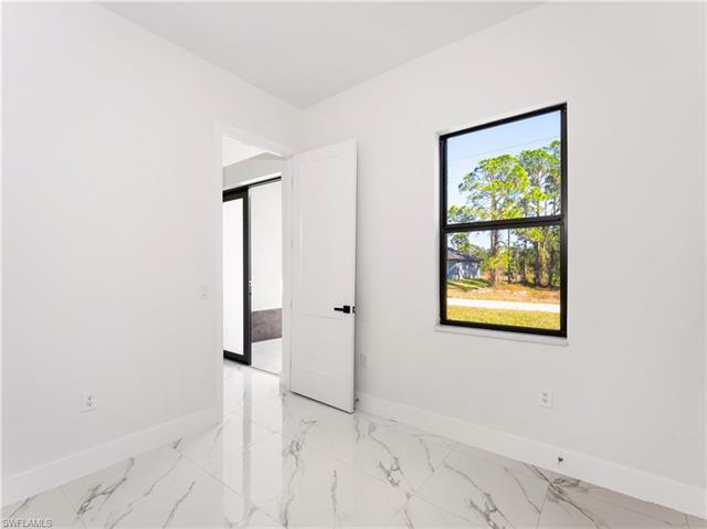 Spare room featuring baseboards and marble finish floor