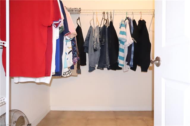Spacious closet featuring tile patterned flooring