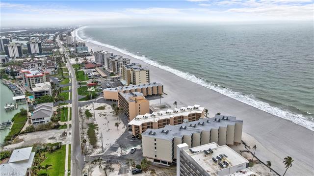 Aerial view with a city view, a view of the beach, and a water view